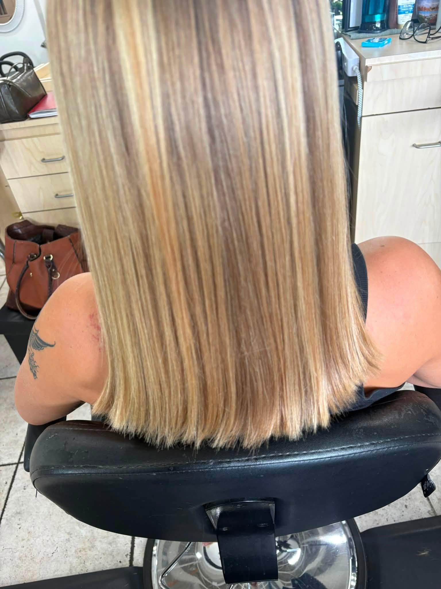 Back view of a precision blonde long bob